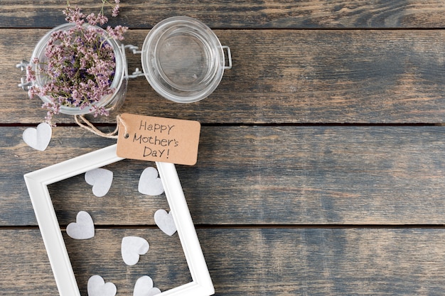 Free photo happy mothers day inscription with flowers in can and frame