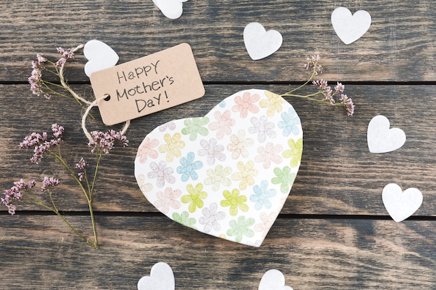 Happy Mothers Day inscription with flowers an paper hearts 