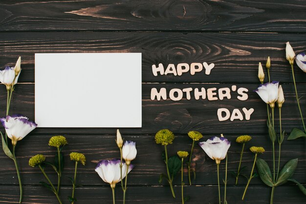 Happy Mothers Day inscription with flowers and paper  