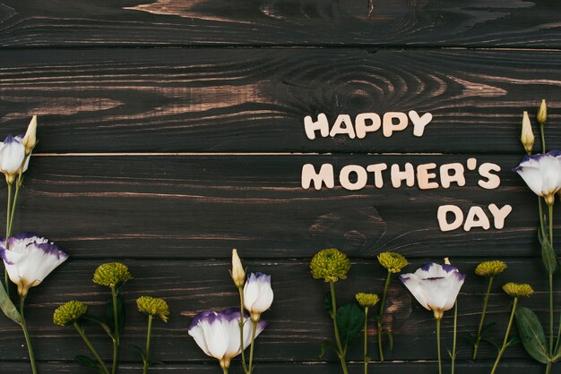 Happy Mothers Day inscription with flowers 