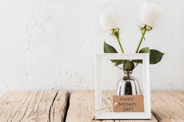 Happy Mothers Day inscription with white roses in vase