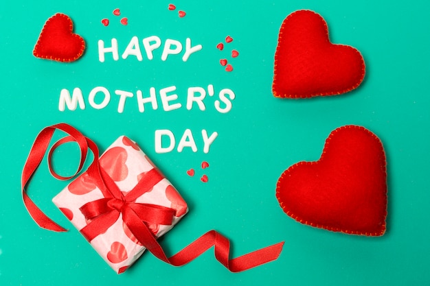 Free photo happy mothers day title near hearts and present box