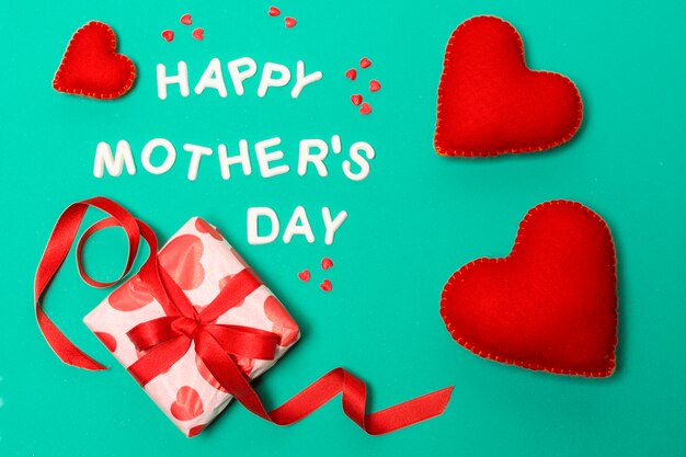 Happy mothers day title near hearts and present box