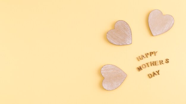 Free photo happy mothers day words and wooden hearts