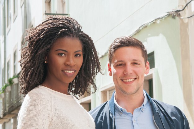 Happy multicultural couple posing outdoors