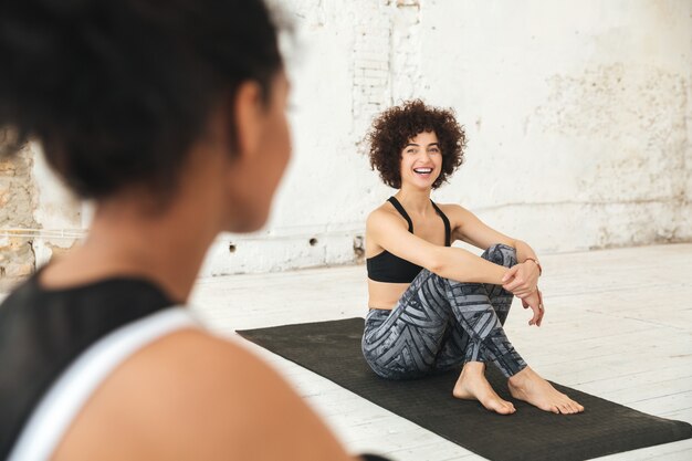 Happy multiethnic people in yoga studio