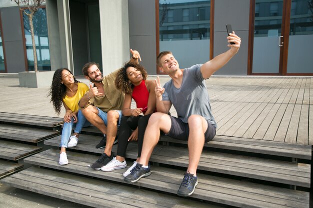 Happy multiethnic students taking selfie