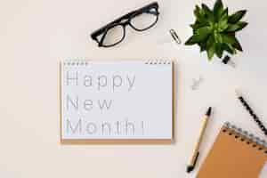 Free photo happy new month wording on notepad