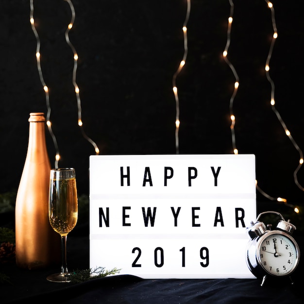 Happy New Year 2019 inscription on board with clock 