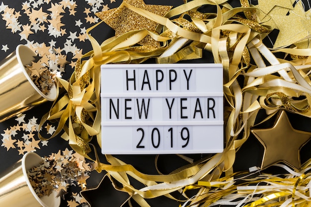 Happy New Year 2019 inscription on board with spangles