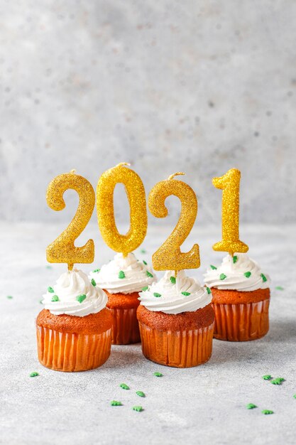 Happy New Year 2021,cupcakes with golden candles.