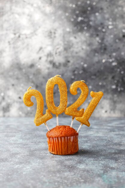 Happy New Year 2021,cupcakes with golden candles.