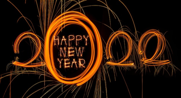 Happy new year 2022 sparkling burning text happy new year 2022 isolated on black background beauti