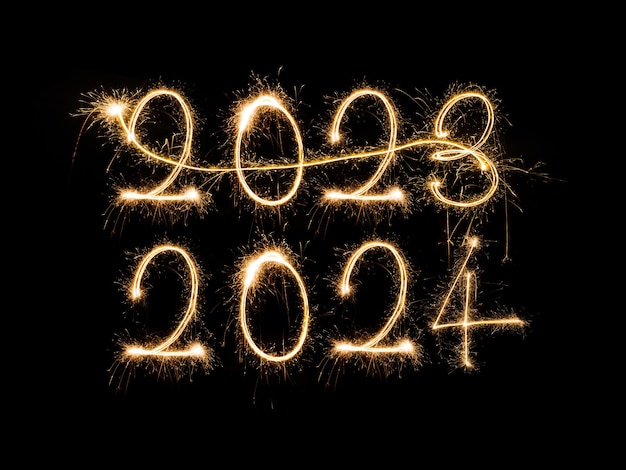Free photo happy new year 2024 sparkling burning text happy new year 2024 isolated on black background