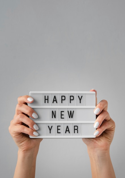 Free photo happy new year card being held in hands with copy space