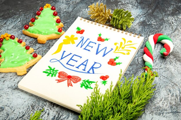 Happy new year. Front view delicious tree biscuits with new year note