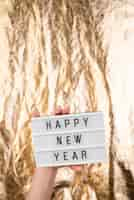 Free photo happy new year plate with blurred golden background