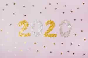무료 사진 황금 별을 가진 숫자 2020를 가진 새해 복 많이 받으세요