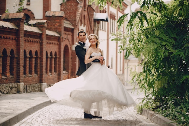 Happy newlyweds posing in the town