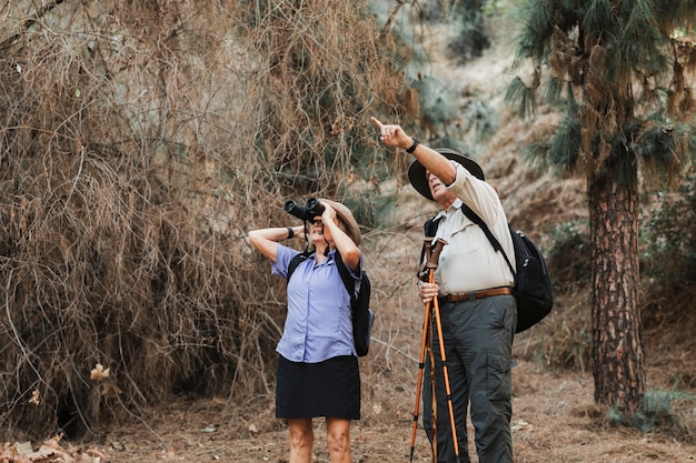 Happy old couple enjoying nature in the Californian forest