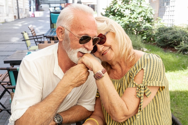 Free photo happy old man kissing ladys hand