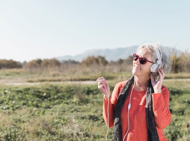 Happy old woman listening to music