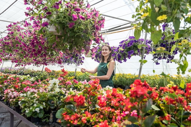 Счастливый обладатель цветочной фермы поливает и ухаживает за цветами