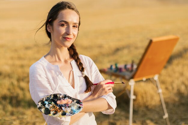 Happy painter woman in the nature