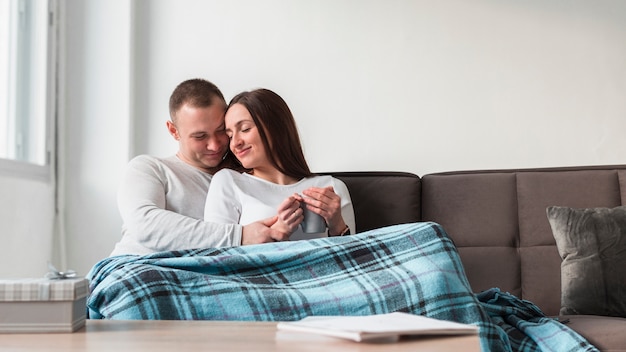Happy parents on the couch at home