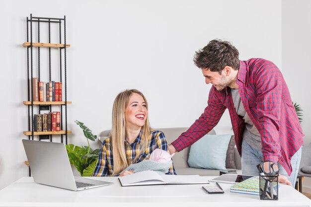 Happy parents with baby at desk