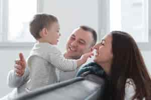 Free photo happy parents with child at home