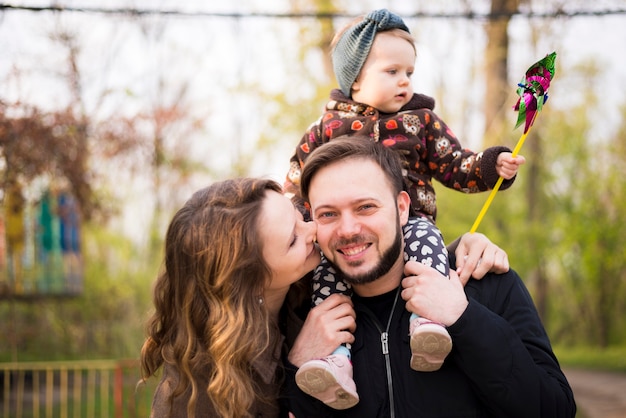 Free photo happy parents with child in nature