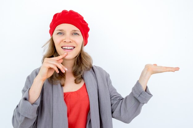 Happy pensive woman demonstrating good product