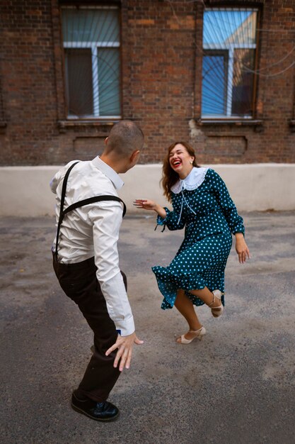 Happy people dancing together full shot