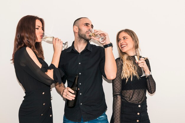 Happy people drinking champagne from glasses 