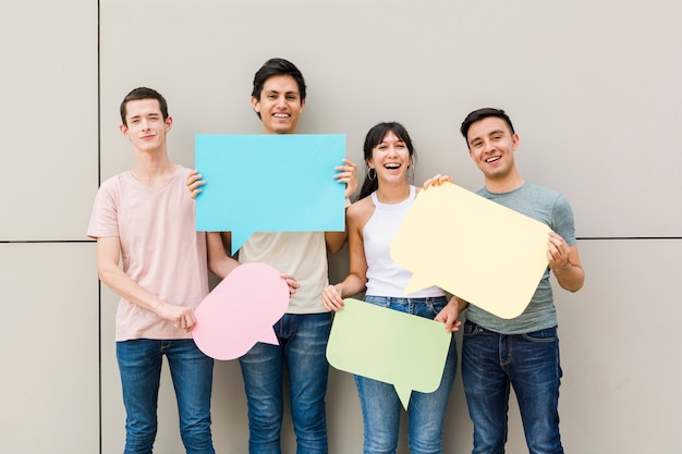 Free photo happy people holding speech bubbles