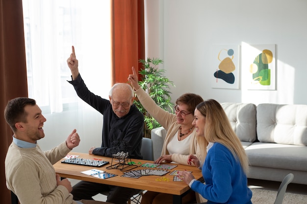 Free photo happy people playing bingo medium shot