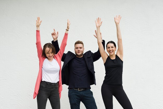 Happy people raising hands up