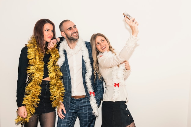 Happy people taking selfie with smartphone 