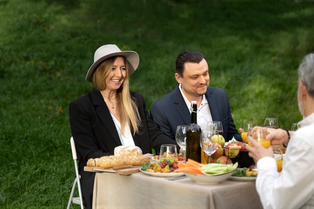 Happy people with food outdoors