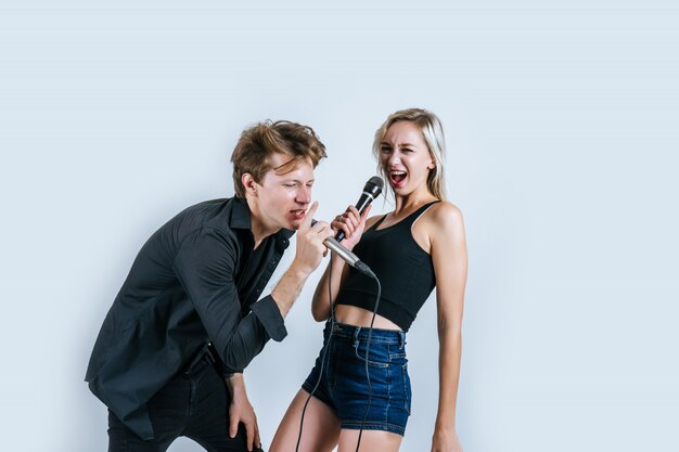 Happy portrait of Couple holding microphone and sing a song