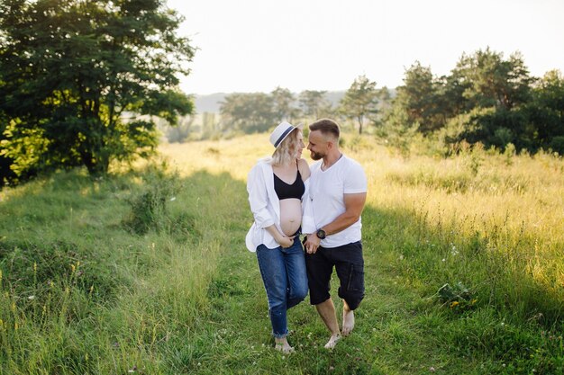 Happy portrait of loving couple on a walk in the park on a sunny day.