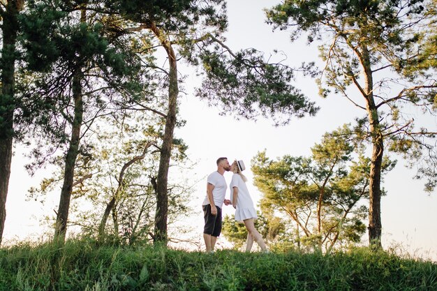 Happy portrait of loving couple on a walk in the park on a sunny day.