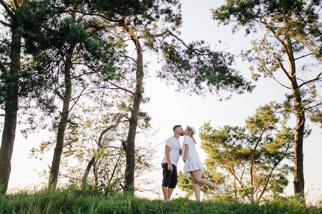 Happy portrait of loving couple on a walk in the park on a sunny day.