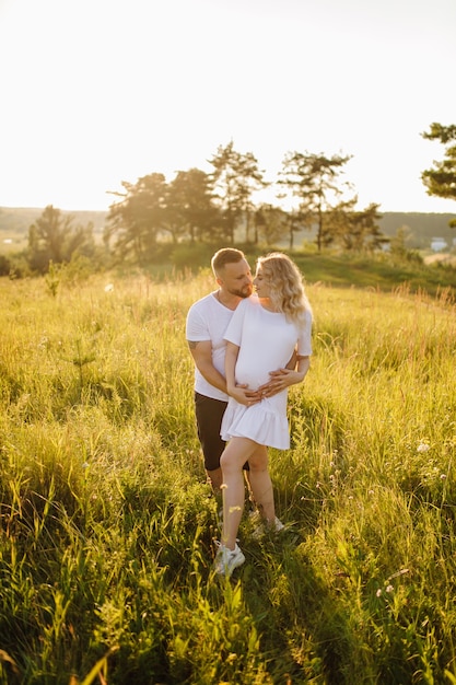 Happy portrait of loving couple on a walk in the park on a sunny day.