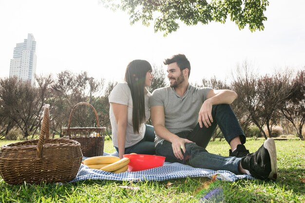 Happy portrait of young couple enjoying in the picnic