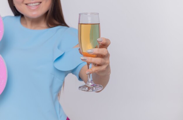 happy and positive asian woman holding glass of champagne