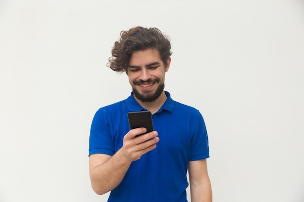 Happy positive guy using cellphone