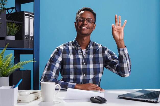 Happy positive smiling heartily young adult approving project idea while making cool symbol with hand. Cheerful joyful business man in office validating worker good job with great work hand gesture.