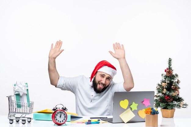 Happy positive young businessman with santa claus hat working at christmas day